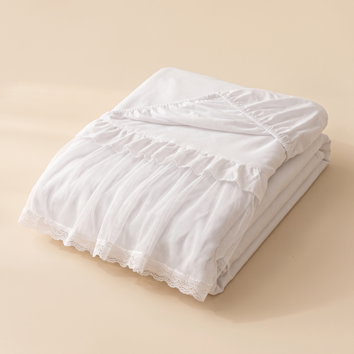 Fitted Ruffled Bed Skirt – Lace Trim in White – folded in a neat stack on a plain beige background