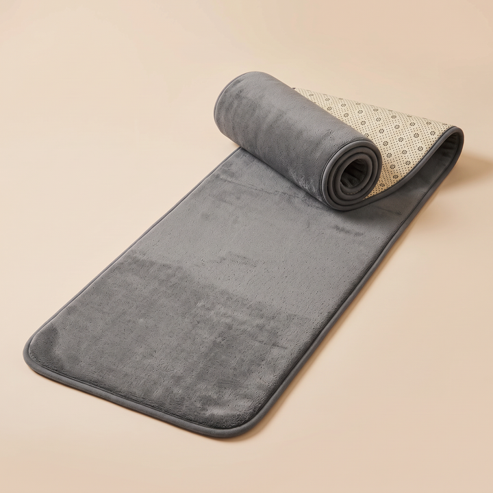 Flannel Kitchen Rug – Cushioned, Non-Slip in Gray – partly rolled up showing dotted backing on a peach background