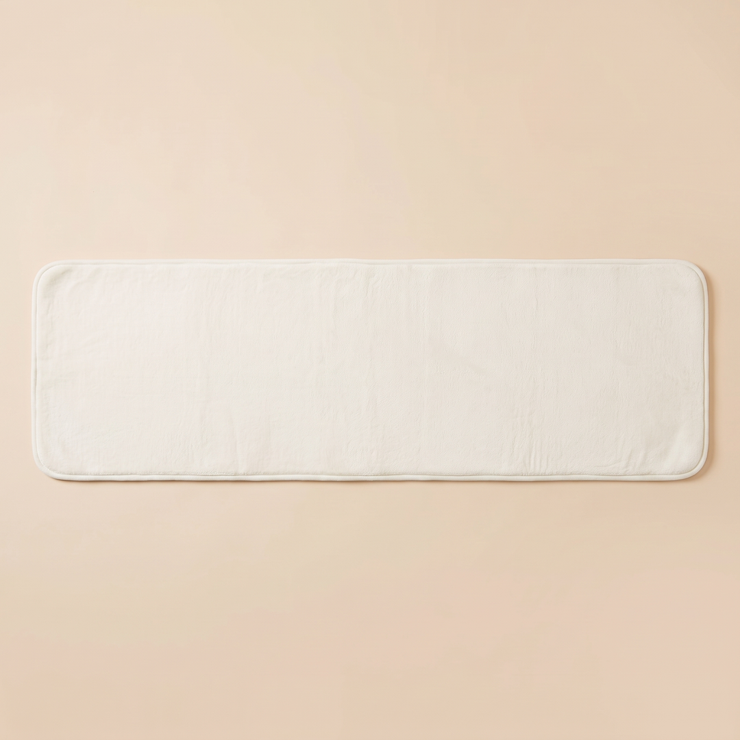 Flannel Kitchen Rug – Cushioned, Non-Slip in White – laid flat on a plain peach background, shown from above