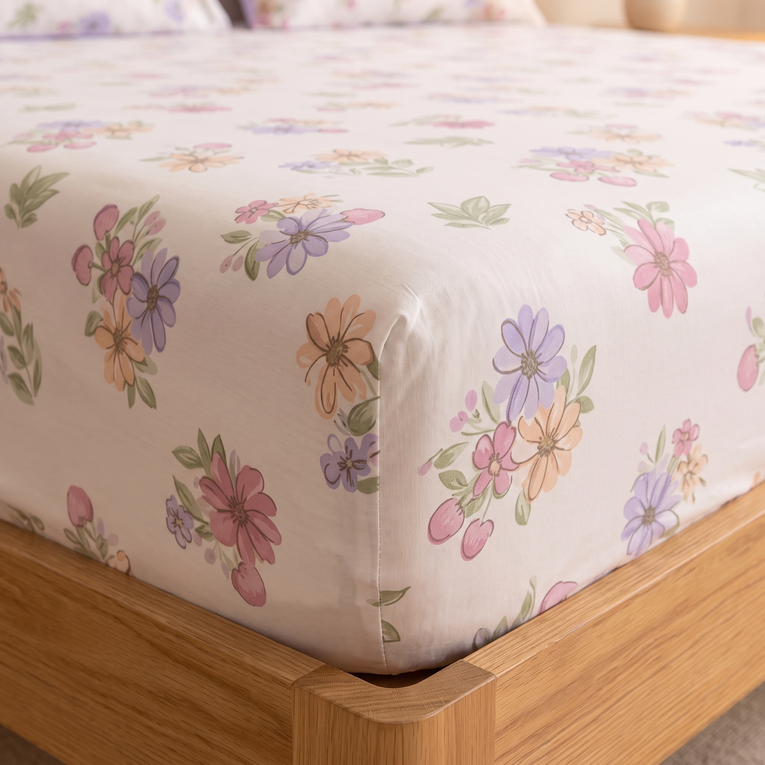Floral Cotton Fitted Sheet Set with 2 Pillowcases in White – Wildflowers – close-up of a fitted corner on an oak bed frame