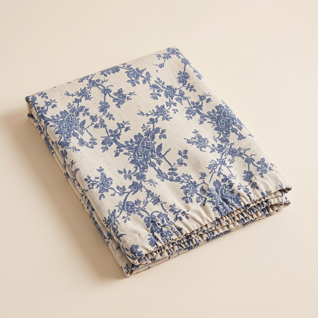 Floral Curtain Panel – Rod Pocket in Blue Floral – folded neatly on a plain cream background, seen from above