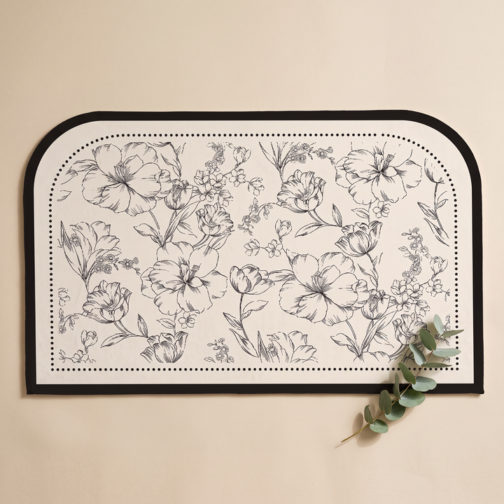 Quick-Dry Bath Mat – Floral, Non-Slip in Arch – with a eucalyptus sprig resting on its lower right corner