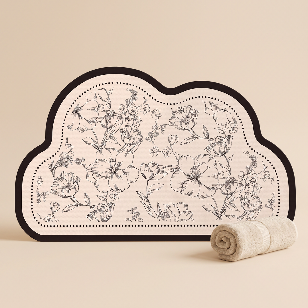 Quick-Dry Bath Mat – Floral, Non-Slip in Cloud – standing upright against beige backdrop beside a rolled cream towel