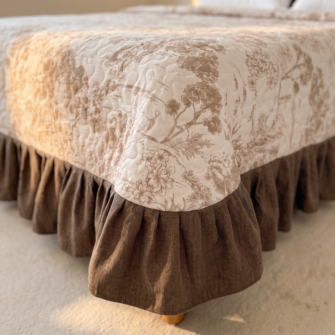 Floral Quilt with Ruffled Edge in Cream Floral – close-up of the bed corner showing the brown ruffled skirt