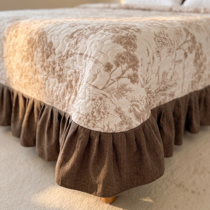 Floral Quilt with Ruffled Edge in Cream Floral – close-up of the bed corner showing the brown ruffled skirt