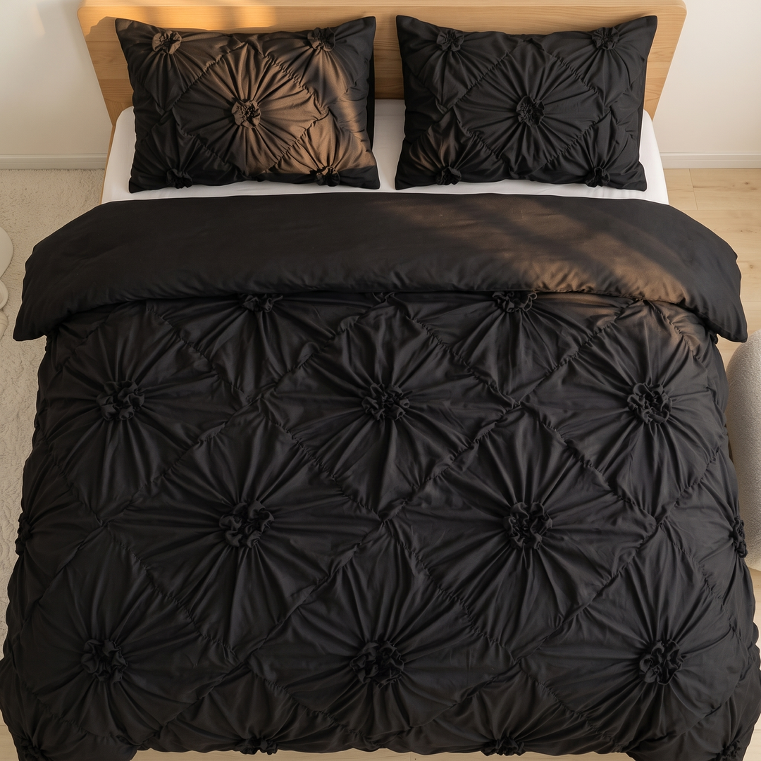 Flower Duvet Cover Set – Ruffled 3D Rosettes in Black – top-down view of bed with two pillows in sunlight
