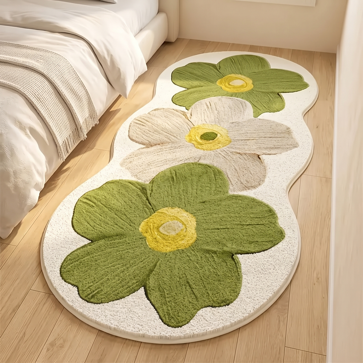 Flower Rug – Bedside Runner in Moss Green – on a wood floor beside a bed with neutral bedding
