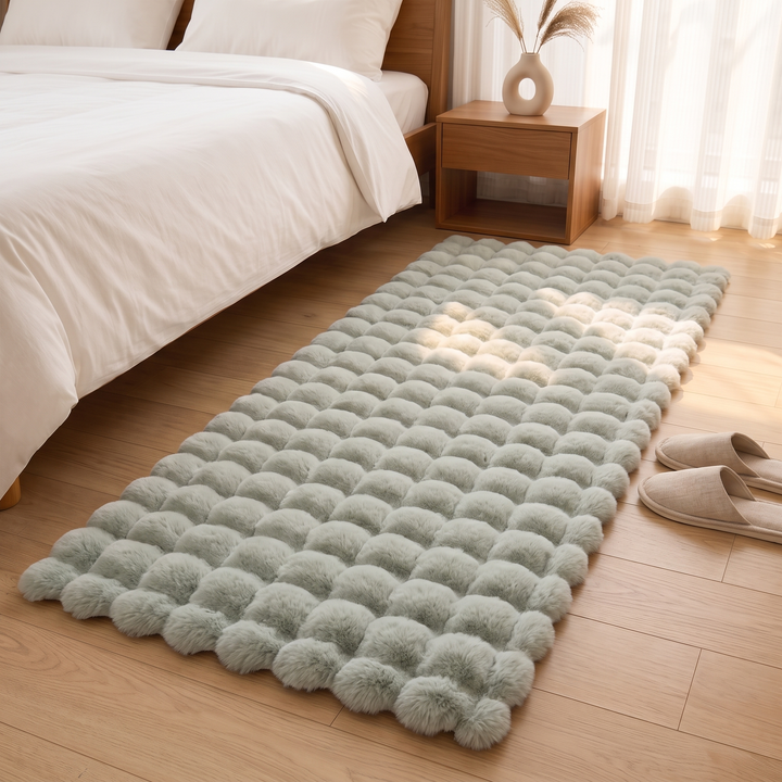 Fluffy Faux Fur Rug – Bubble Texture in Sage – with slippers at the edge and nightstand behind