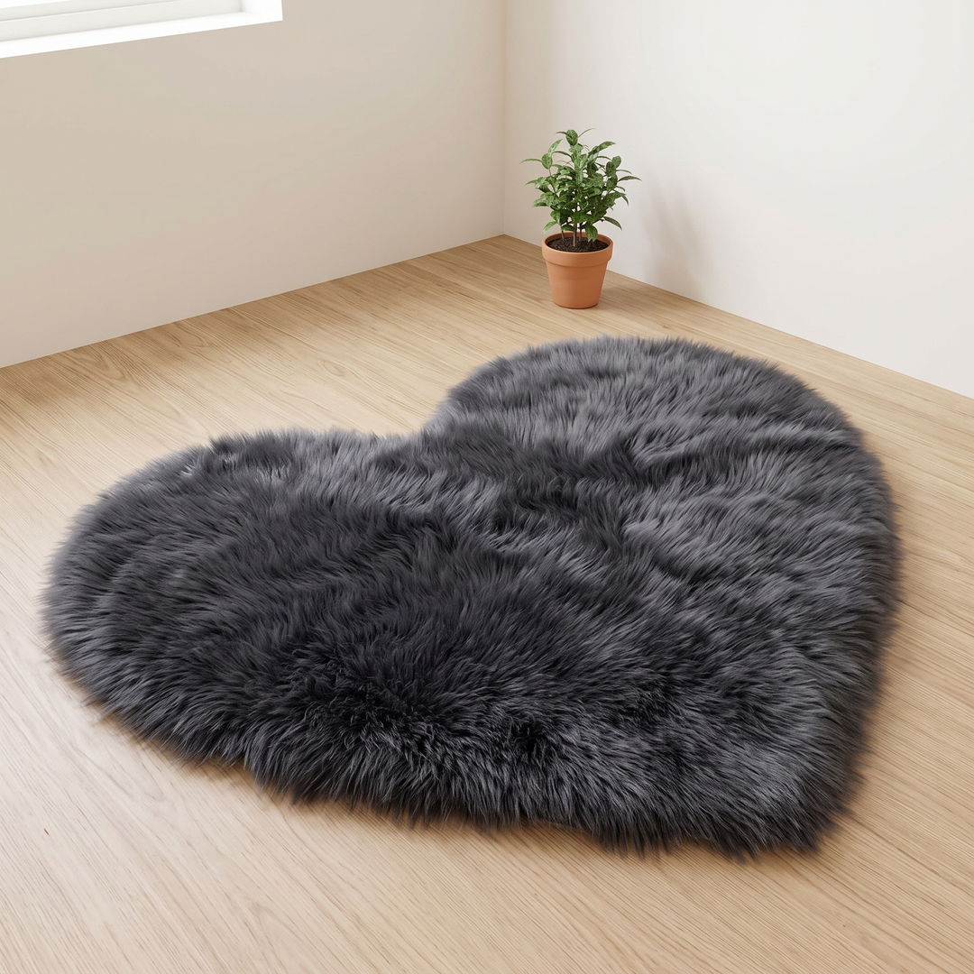 Fluffy Heart Rug – Faux Fur in Dark Gray – on light wood floor in an empty room with small potted plant