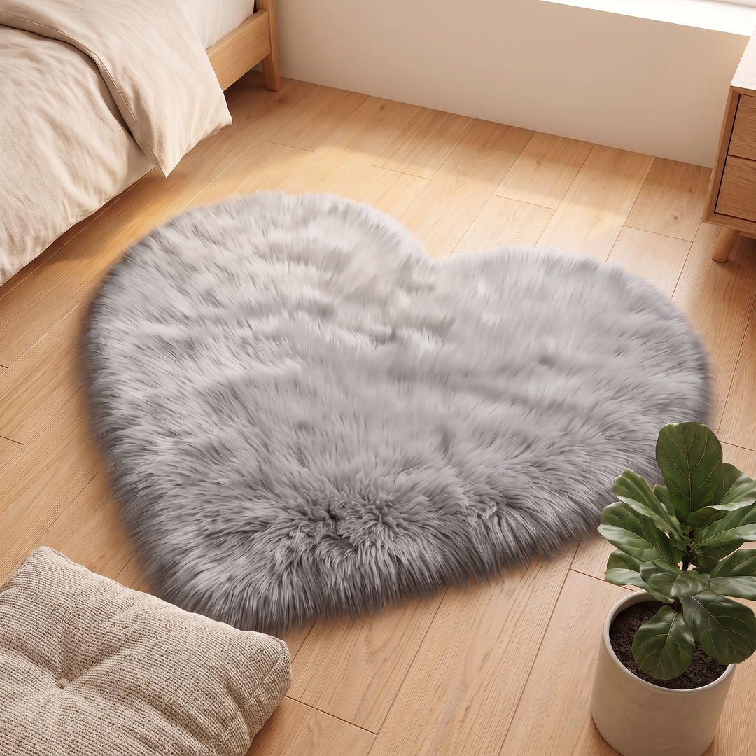 Fluffy Heart Rug – Faux Fur in Gray – between a floor cushion and a potted plant