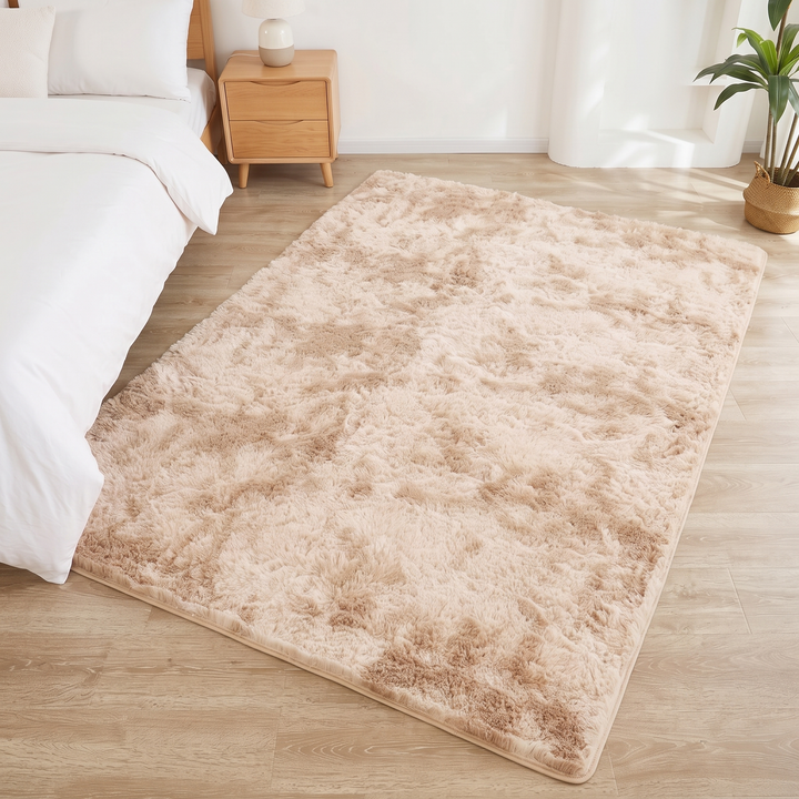 Fluffy Shag Rug in Beige – Tie-Dye – high-angle view with wooden nightstand and potted plant nearby