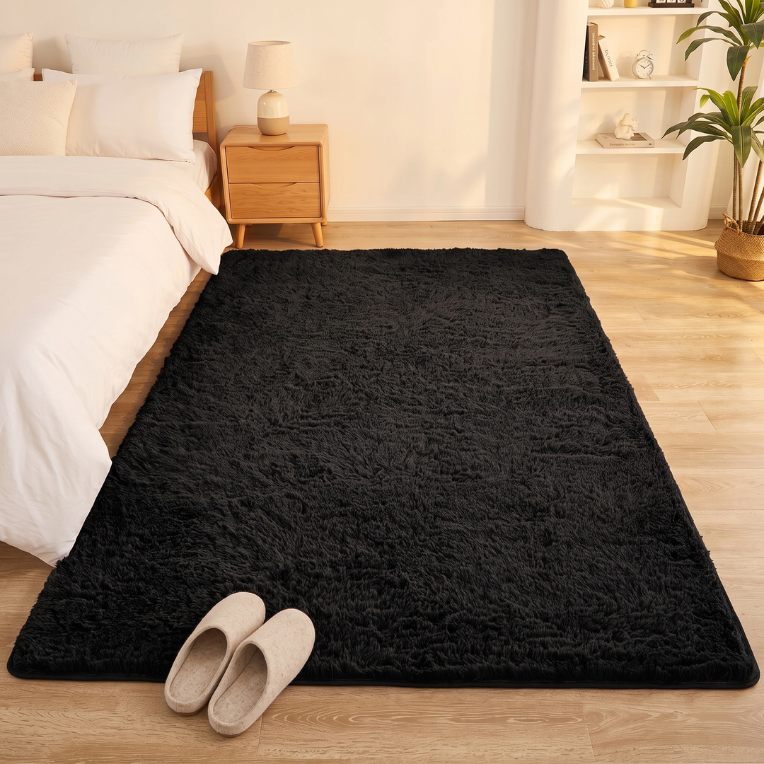 Fluffy Shag Rug in Black – with a pair of slippers placed at its front edge