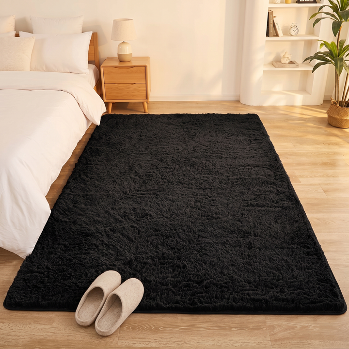 Fluffy Shag Rug in Black – with a pair of slippers placed at its front edge