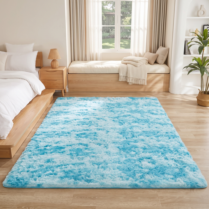 Fluffy Shag Rug in Turquoise – Tie-Dye – centered before a cushioned window seat with folded blanket