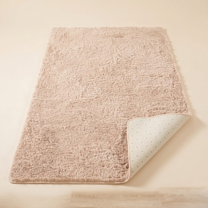 Fluffy Shag Rug in Beige – laid flat with one corner folded over to show the dotted non-slip backing