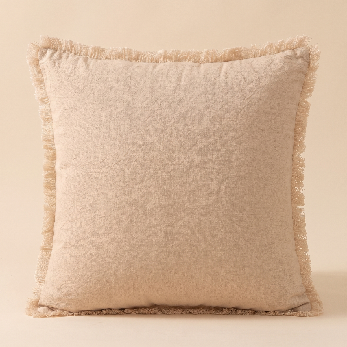 Fringed Pillow Cover in Beige – front view standing upright against a plain neutral backdrop