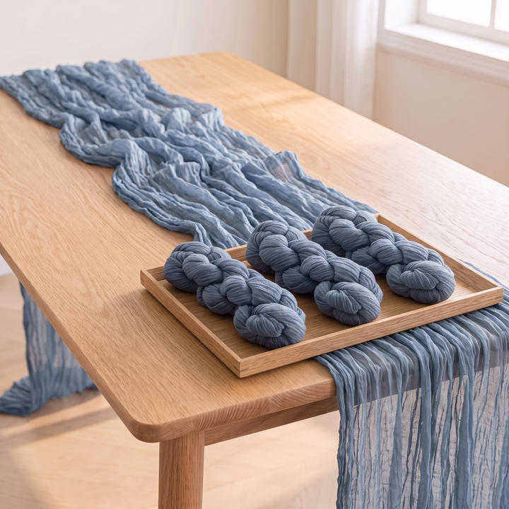 Gauze Table Runners – Set of 4 in Dusty Blue – wooden tray holding three twisted bundles on top of a draped runner