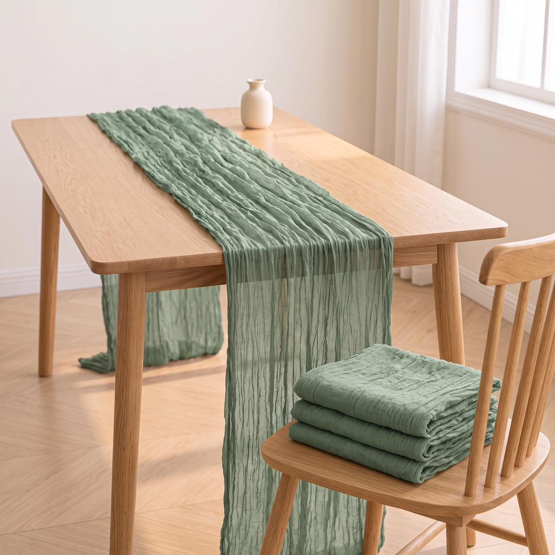 Gauze Table Runners – Set of 4 in Sage – folded stack on a spindle-back chair beside draped table