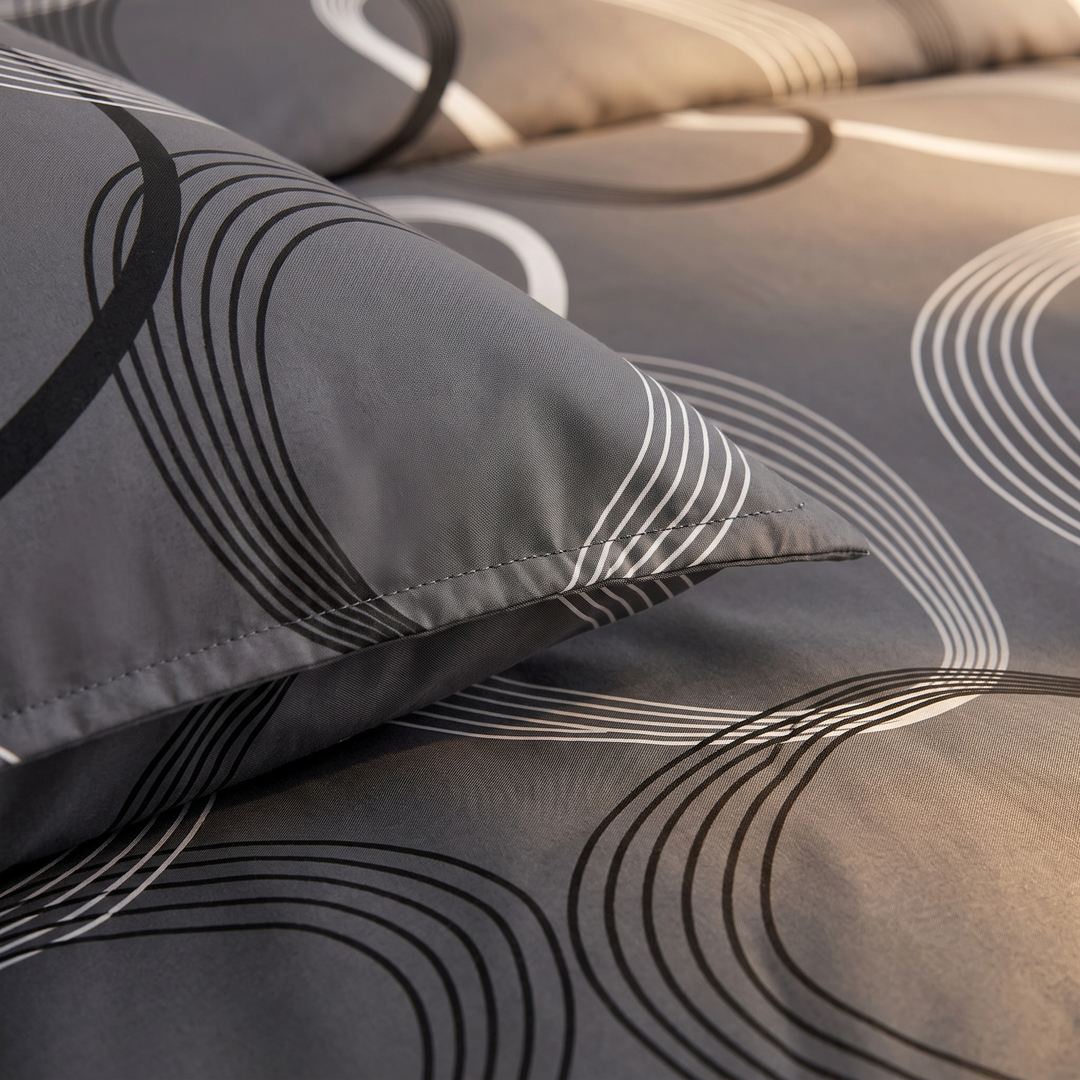 Geometric Duvet Cover Set in Dark Gray Geometric – close-up of a pillowcase edge and curved line print