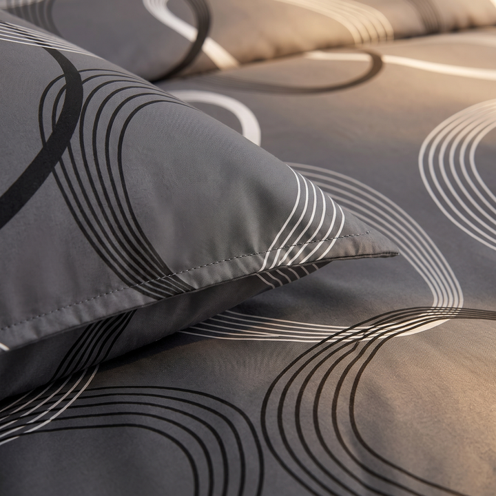 Geometric Duvet Cover Set in Dark Gray Geometric – close-up of a pillowcase edge and curved line print