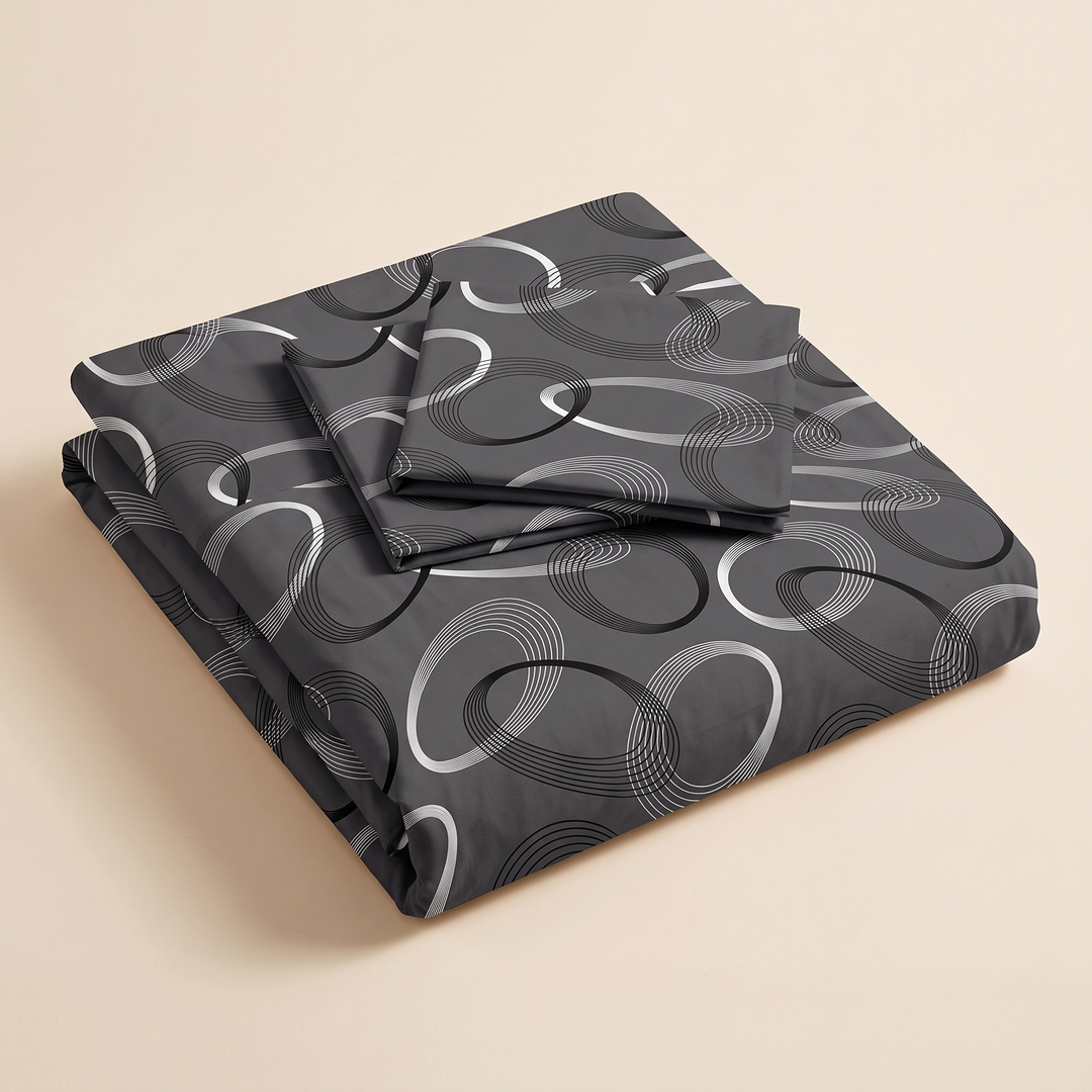 Geometric Duvet Cover Set in Dark Gray Geometric – folded stack with two pillowcases on top against a plain beige background