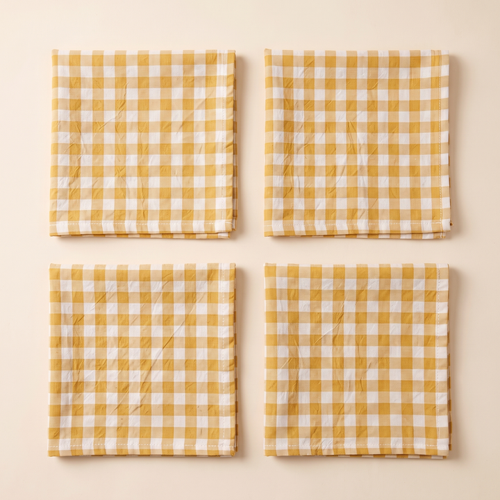 Gingham Cloth Napkins – Set of 4 in Mustard Gingham – four folded napkins in a two-by-two grid, top-down view