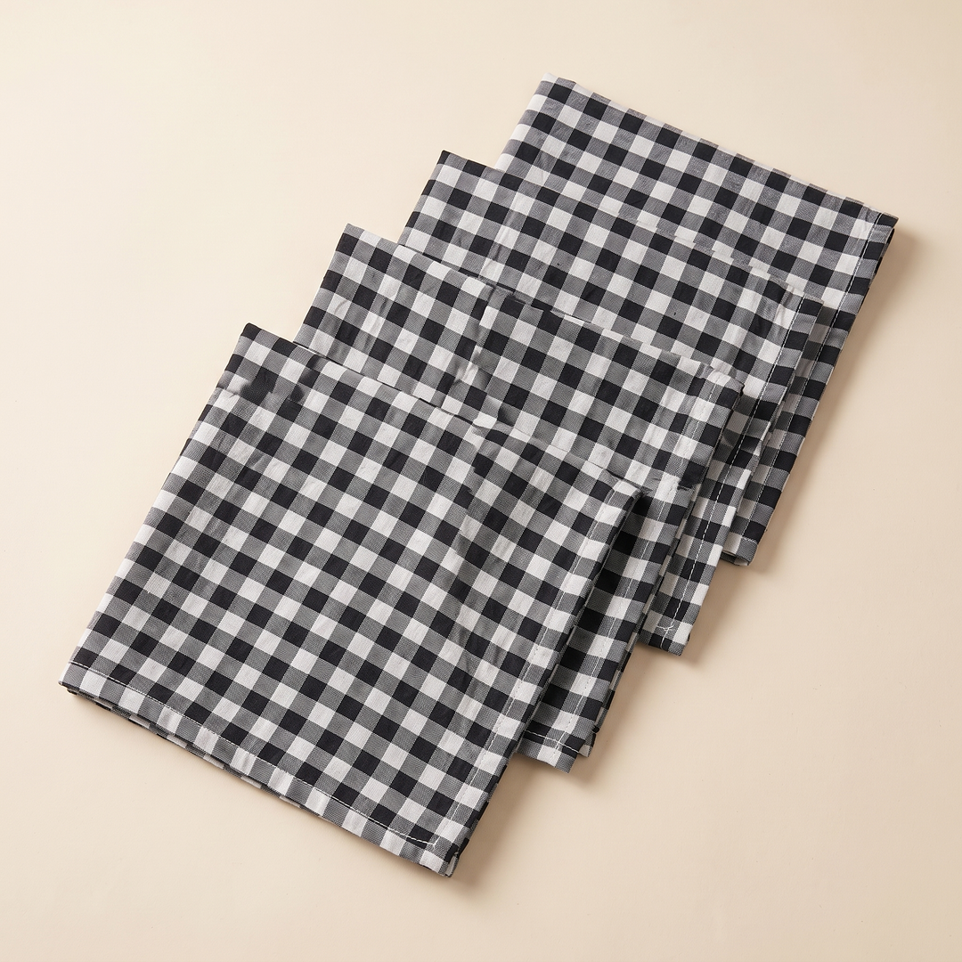 Gingham Cloth Napkins – Set of 4 in Black Gingham – four folded napkins fanned out on a cream background