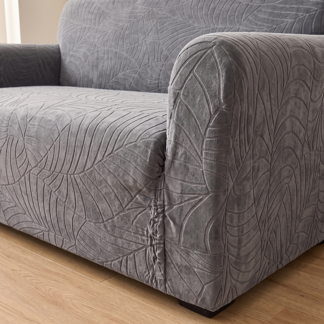 Jacquard Stretch Sofa Cover in Dark Gray – close-up of leaf pattern on armrest and seat cushion