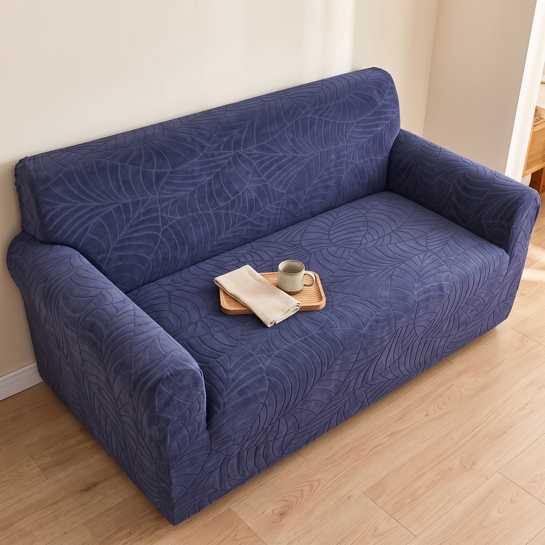 Jacquard Stretch Sofa Cover in Navy Blue – overhead view with mug and napkin on a wooden tray
