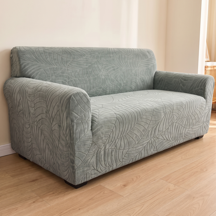 Jacquard Stretch Sofa Cover in Sage – three-quarter view from the left armrest end toward the backrest
