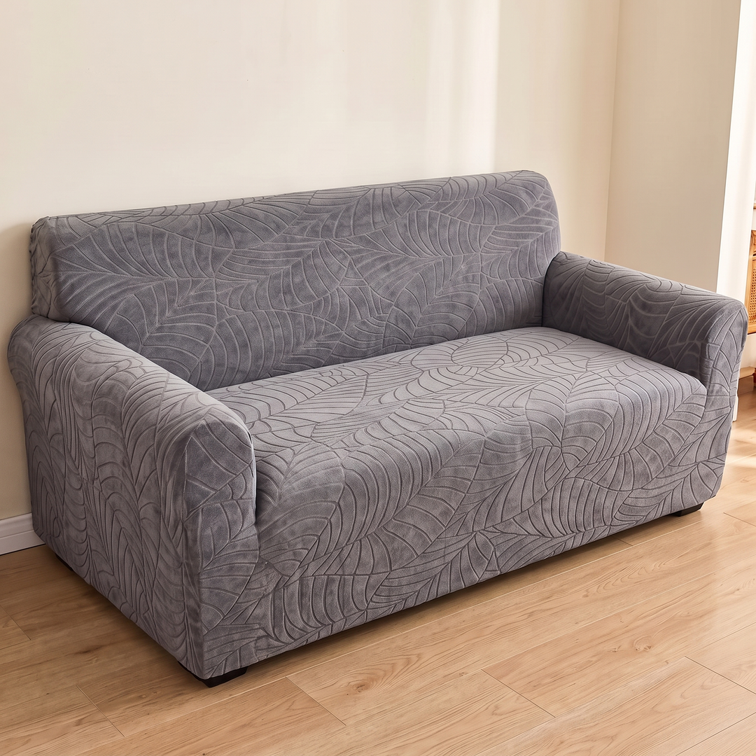 Jacquard Stretch Sofa Cover in Dark Gray – fitted on a two-seater sofa against a cream wall