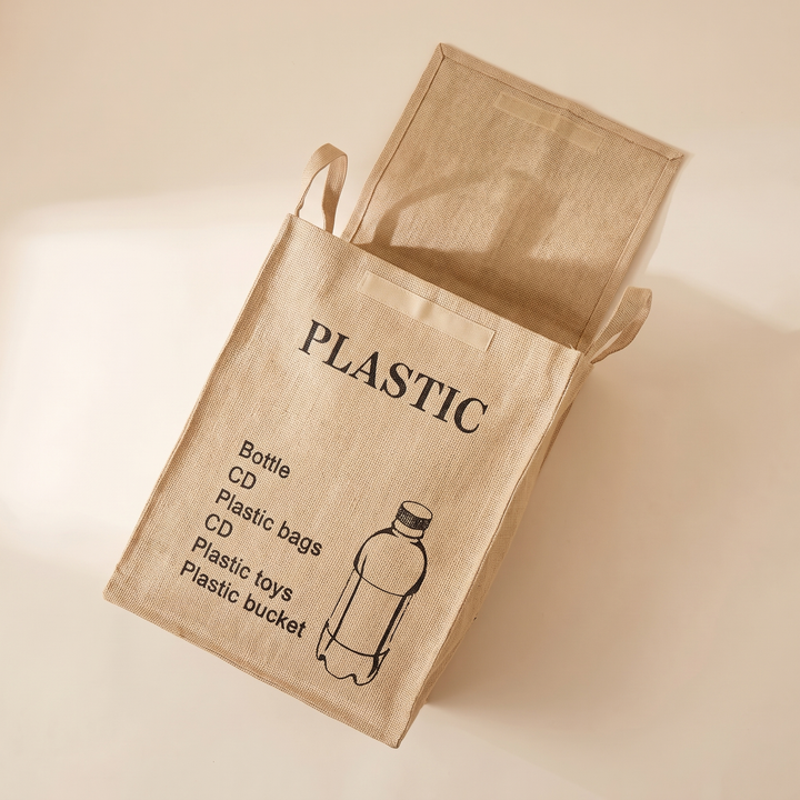 Jute Storage Basket with Lid – Foldable in Natural – Plastic Recycling – lying on its side with lid open on a cream surface
