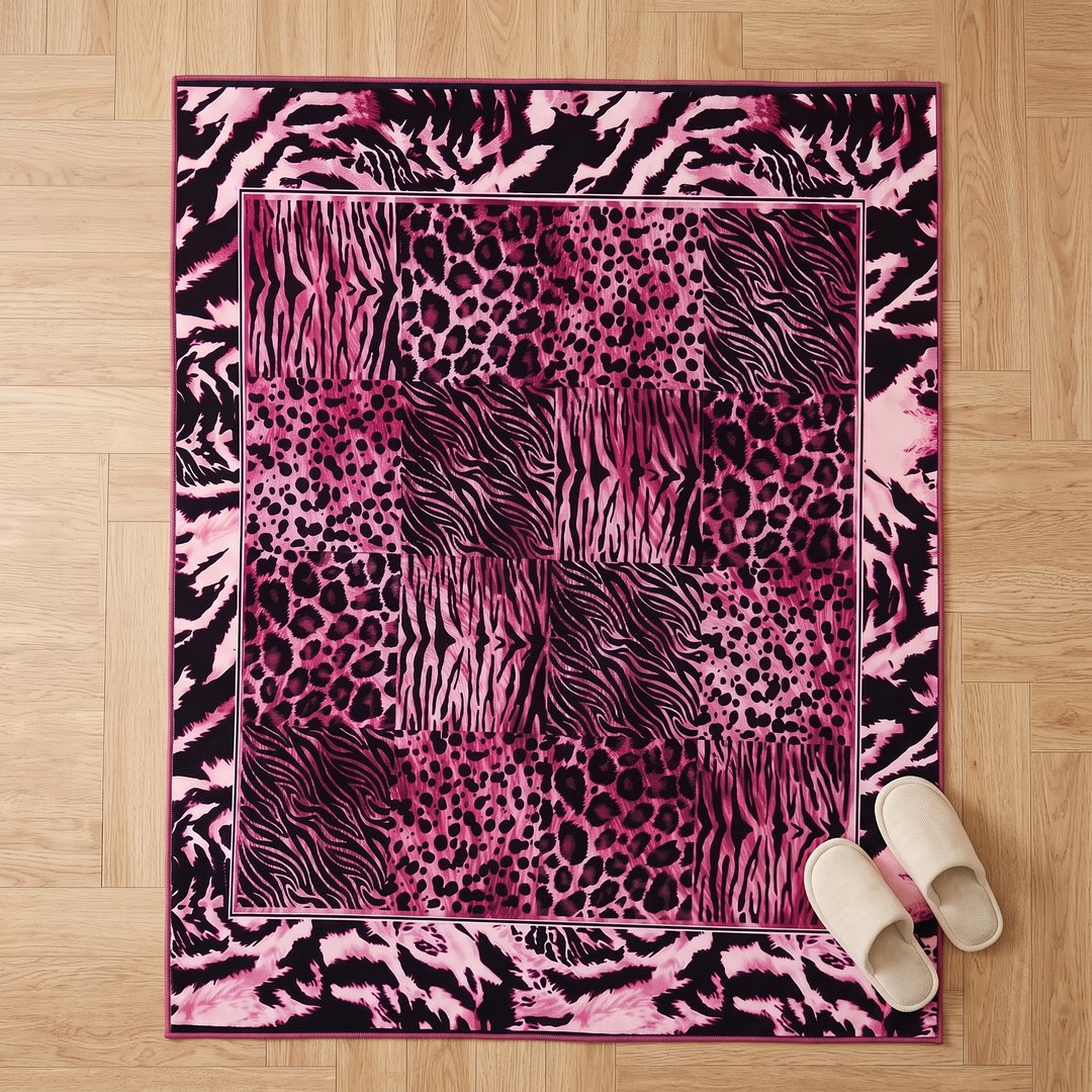 Leopard Print Rug – Washable in Magenta – top-down view on light wood floor with a pair of slippers beside it