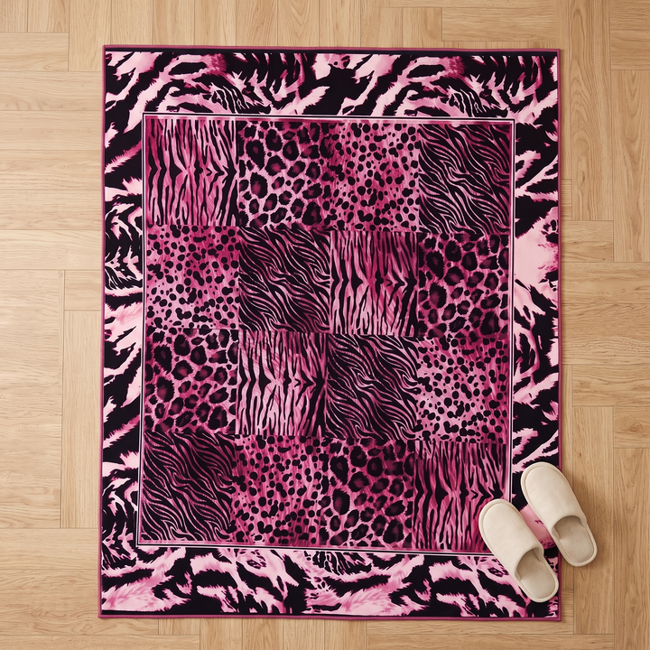 Leopard Print Rug – Washable in Magenta – top-down view on light wood floor with a pair of slippers beside it