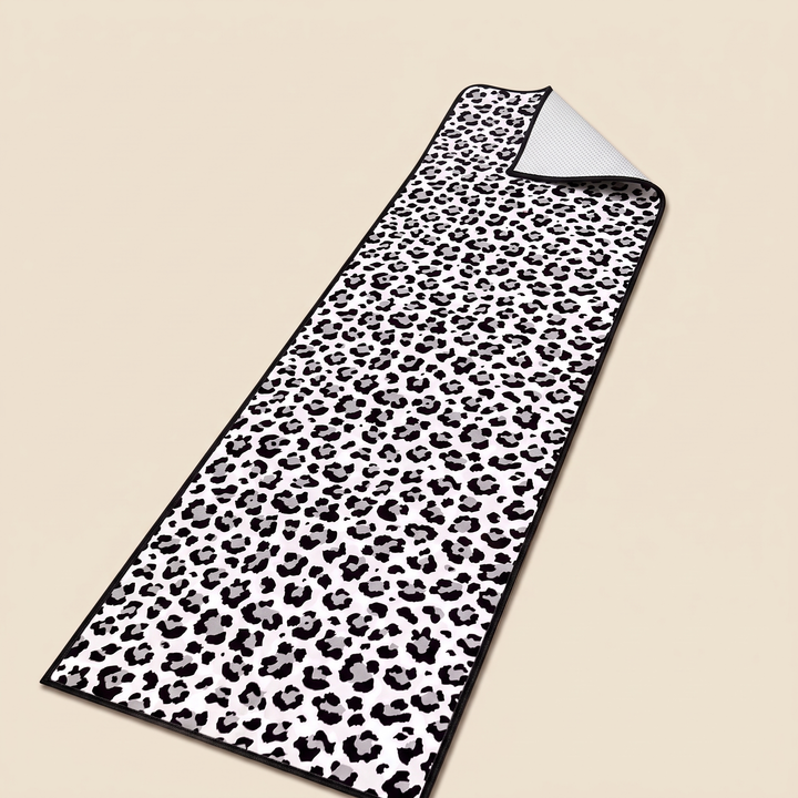 Leopard Print Runner Rug – Washable in White – laid flat on a plain beige background, seen from above at an angle