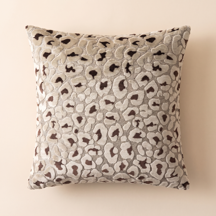 Leopard Print Velvet Pillow Cover in Brown &amp; Beige – flat lay from above on a plain peach backdrop