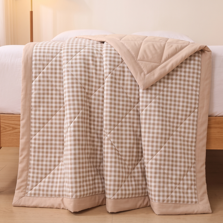 Lightweight Quilted Coverlet in Beige Gingham – draped over the foot of a bed with oak frame