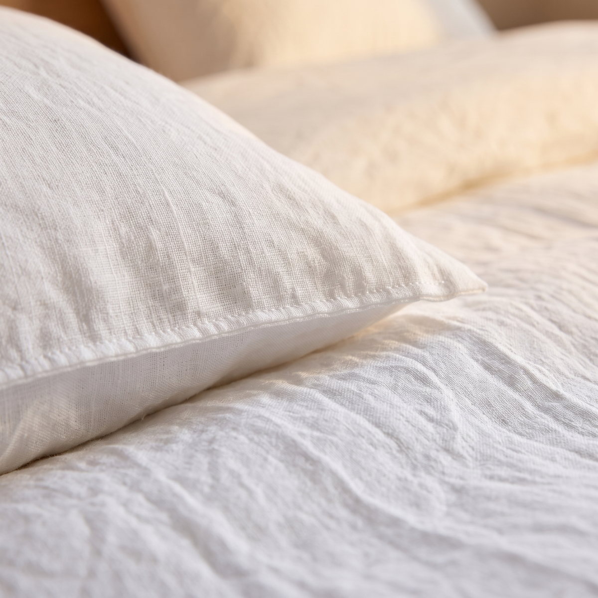 Linen Duvet Cover Set in White – close-up of a pillow edge and rumpled duvet texture