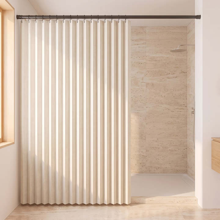 Pleated Fabric Shower Curtain – Linen Look, Extra Wide Sizes in Cream – drawn beside a travertine-tiled walk-in shower with rain showerhead