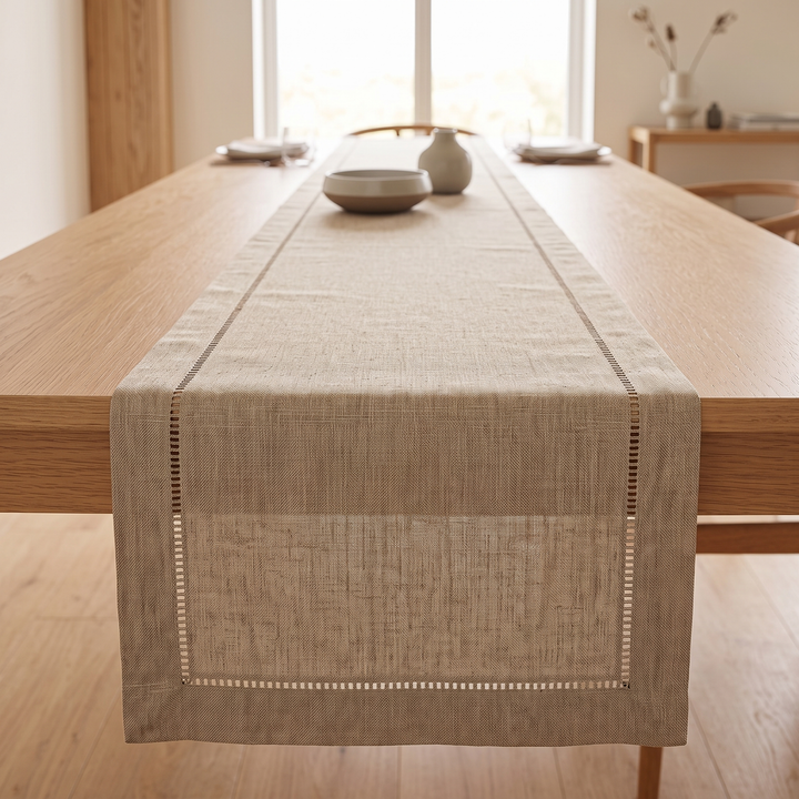 Linen-Look Table Runner – Hemstitch Border in Taupe – with a ceramic bowl and place settings by a window