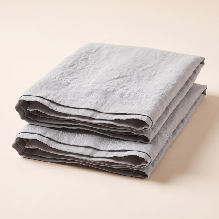 Linen Pillowcases – Set of 2 in Light Gray – folded pair with open ends facing camera, soft shadow
