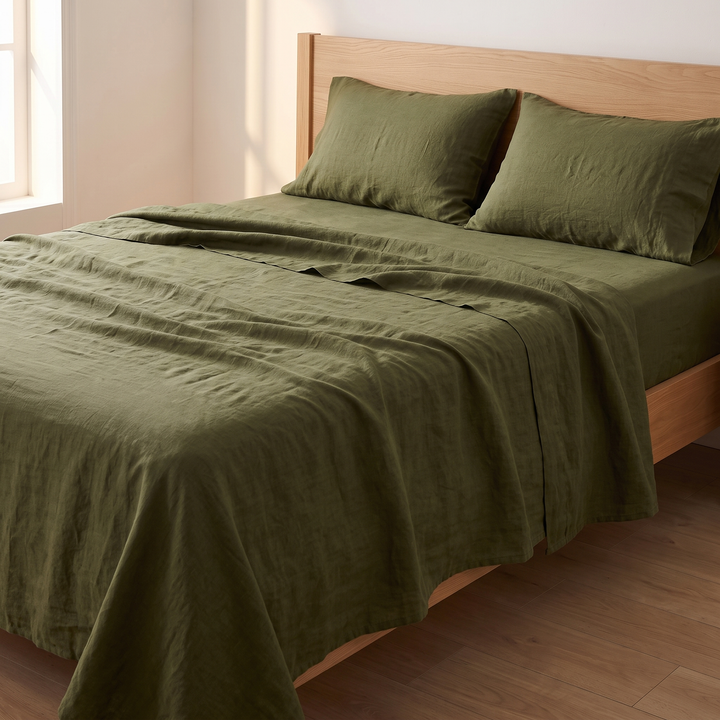 Linen Sheet Set in Olive Green – top sheet draped over the bed edge, pillows at headboard