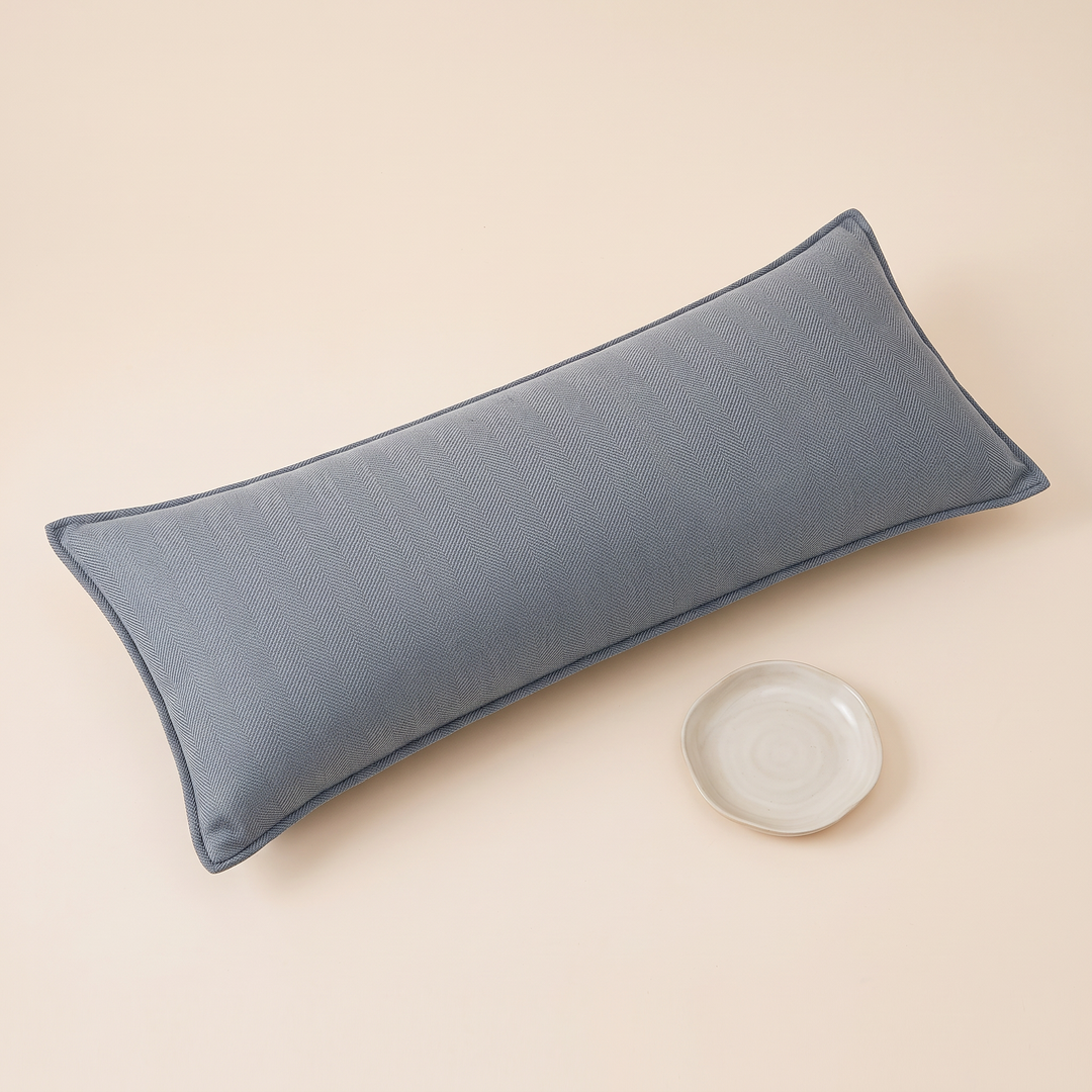 Long Lumbar Pillow Cover in Dusty Blue – with a small round ceramic dish placed beside it