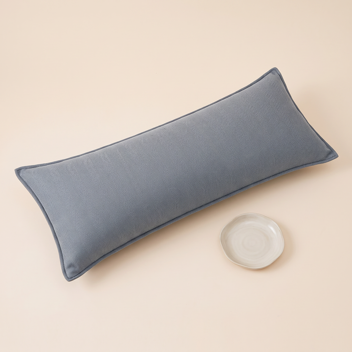 Long Lumbar Pillow Cover in Dusty Blue – with a small round ceramic dish placed beside it