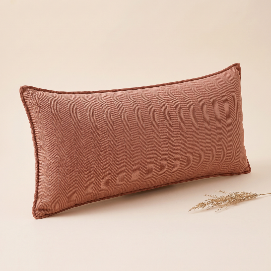 Long Lumbar Pillow Cover in Terracotta – angled with a dried grass plume at lower right