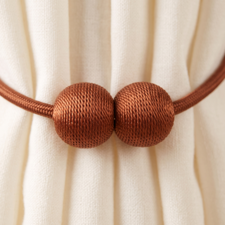 Magnetic Curtain Tiebacks – Set of 2 in Rust – close-up of joined magnetic balls gathering cream linen curtain