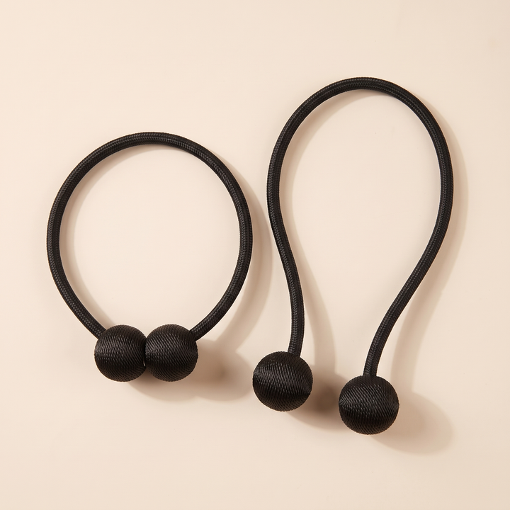 Magnetic Curtain Tiebacks – Set of 2 in Black – clasped ring beside an unclasped loop with balls apart, casting soft shadows