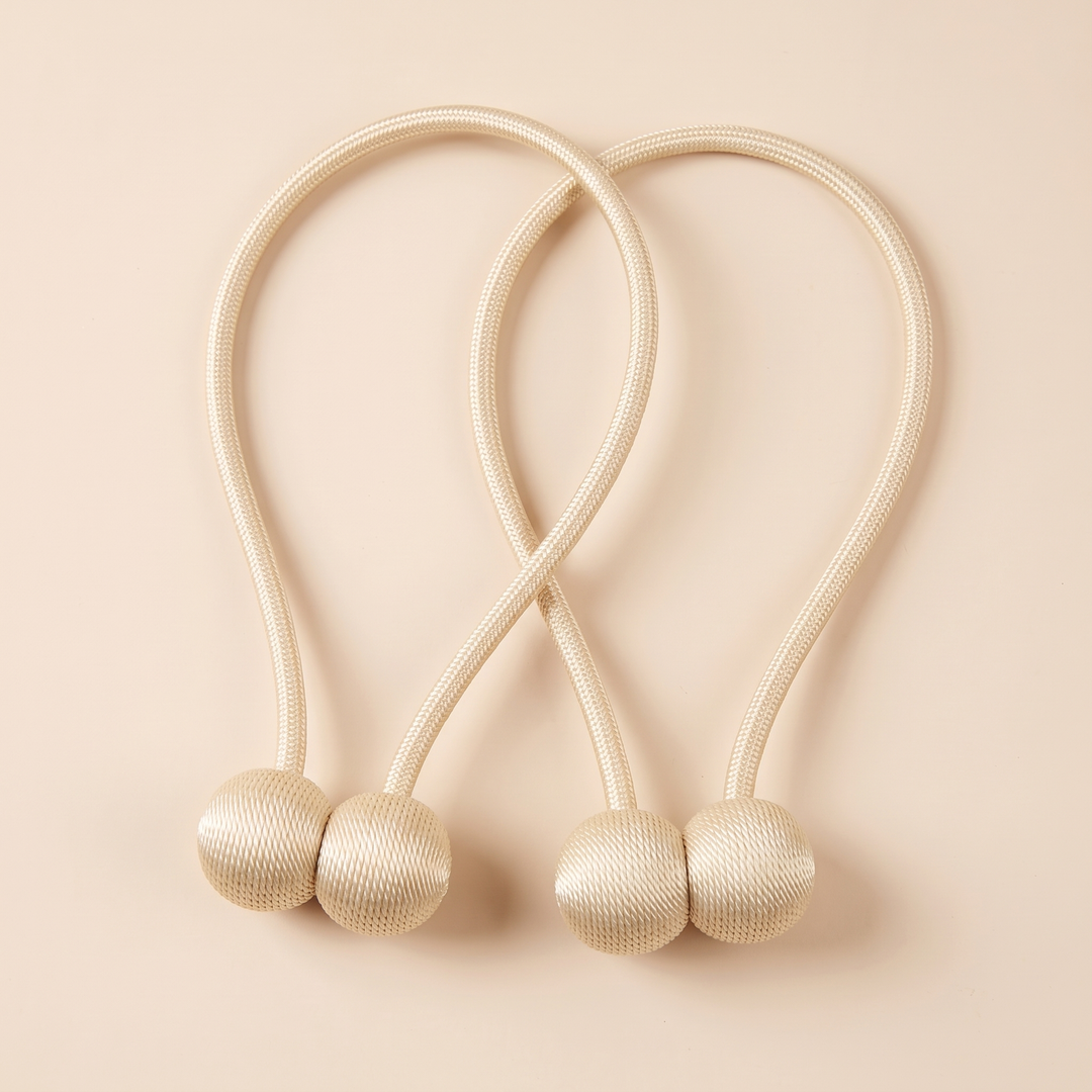 Magnetic Curtain Tiebacks – Set of 2 in Cream – top-down flat lay with rope loops crossing over each other