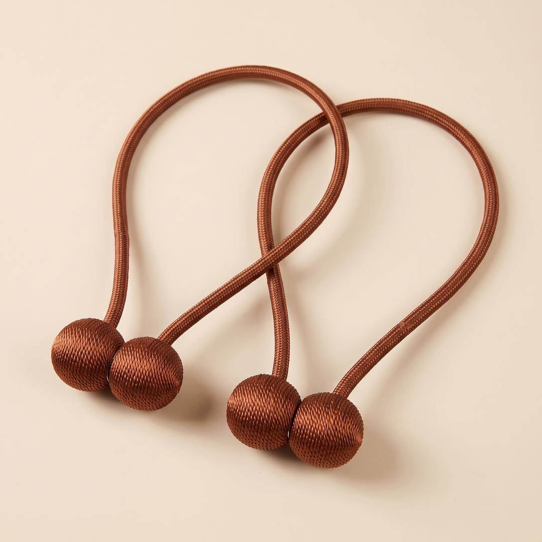 Magnetic Curtain Tiebacks – Set of 2 in Rust – two looped tiebacks with magnetic balls joined, on plain cream background