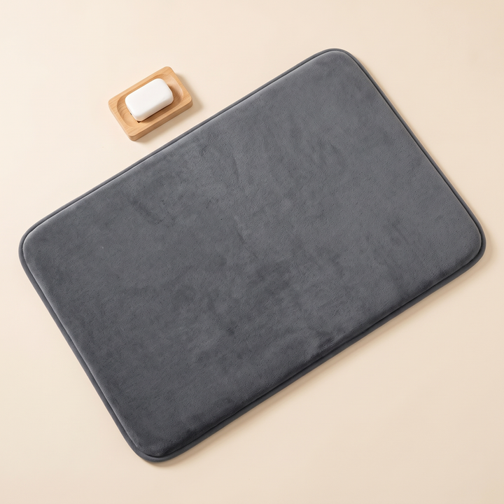 Non-Slip Memory Foam Bath Mat – Plush in Dark Gray – overhead view beside a wooden soap dish with soap